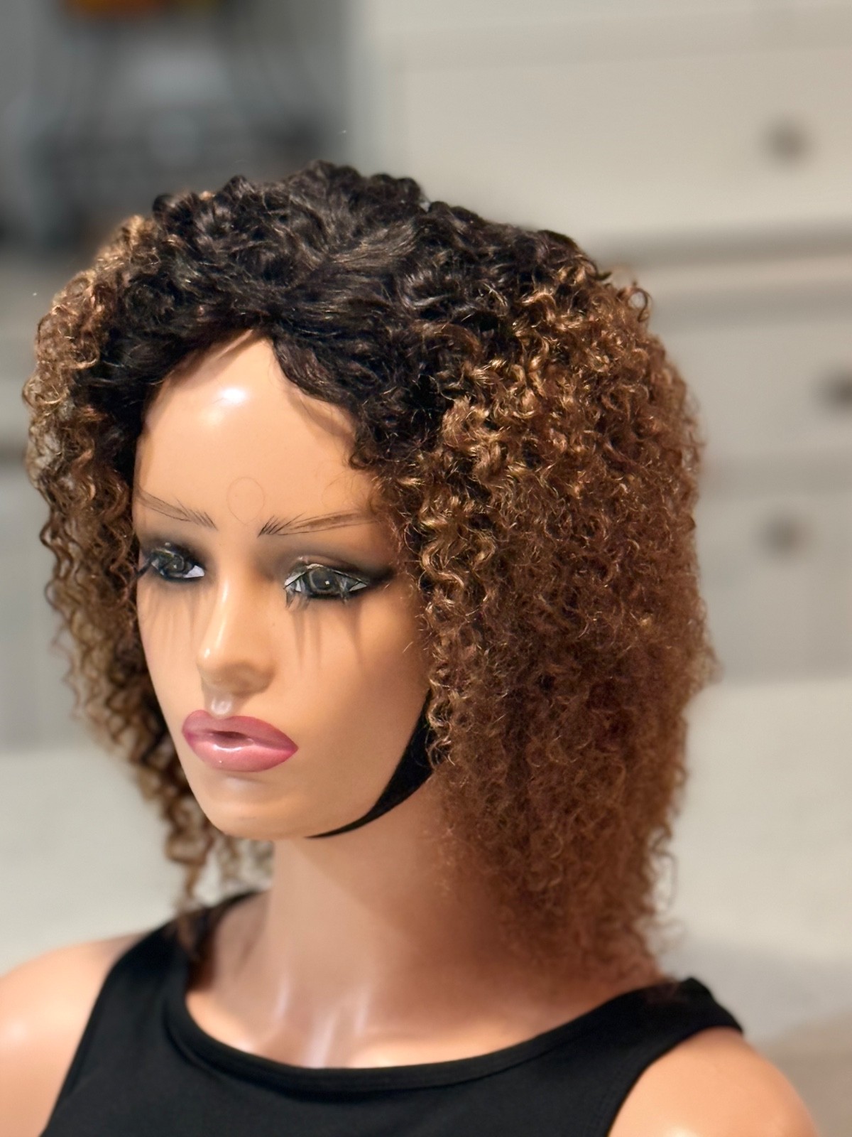 Human hair curly Afro brown wig with a side part.