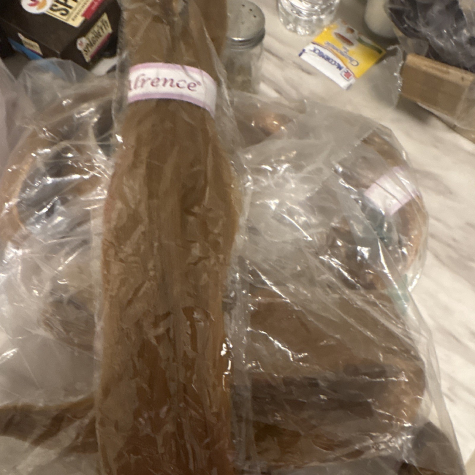 Florence Light Brown Hair Extension in Plastic Packaging, Brand Label Visible