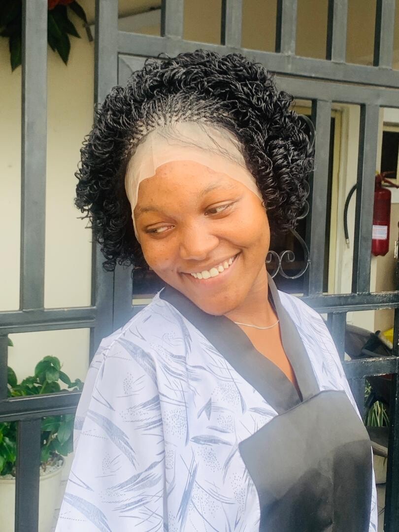 Braided micro twist wig with curly tips made on a full lace wig. Black women’s
