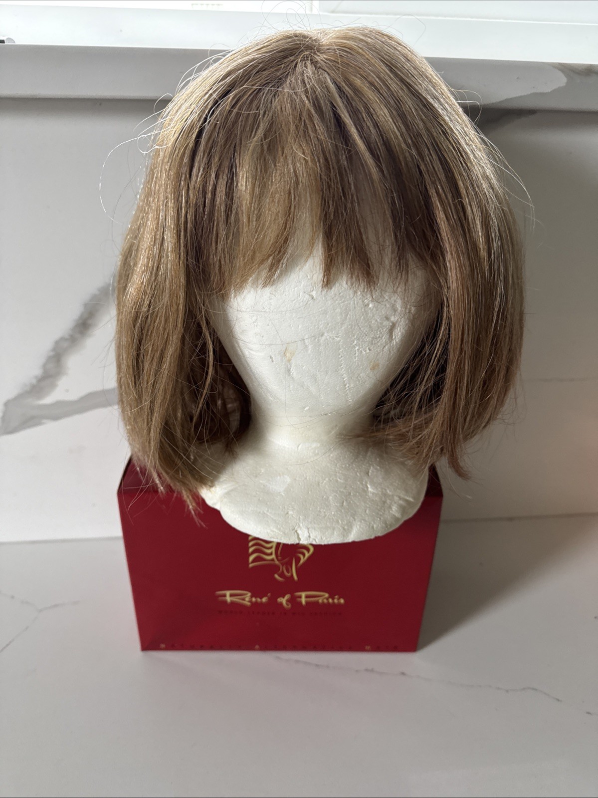 Rene of Paris Synthetic Wig Short Bob with Bangs Blonde Highlighted