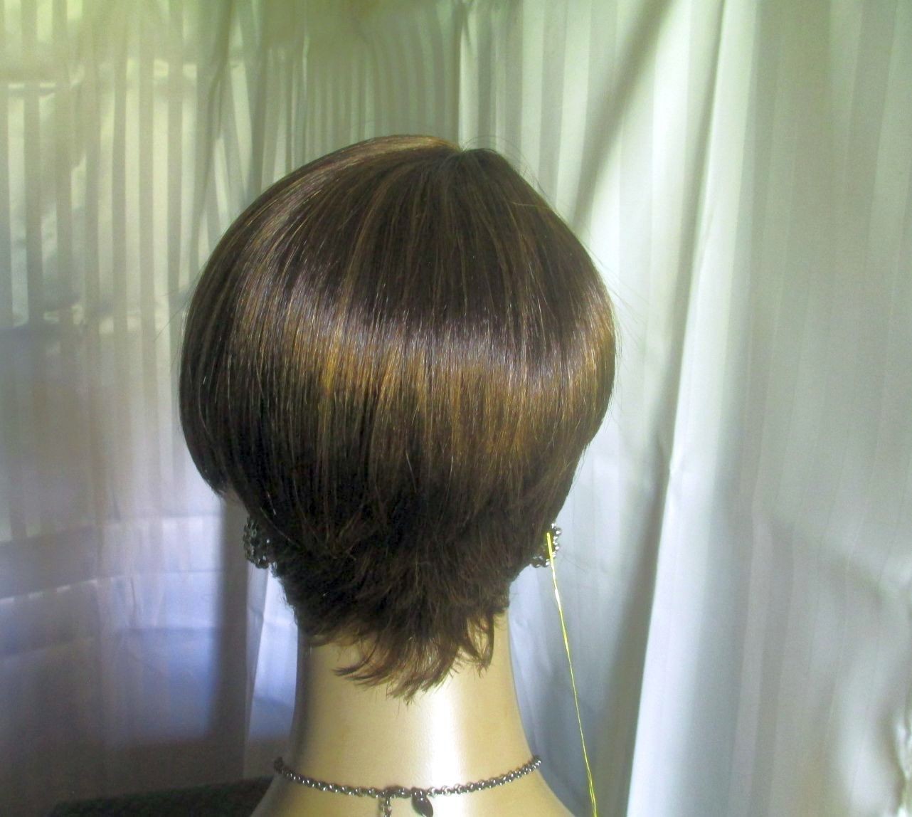 its a wig shortstraight w/bangs dark brown w/strawberry blonde easy to style NEW