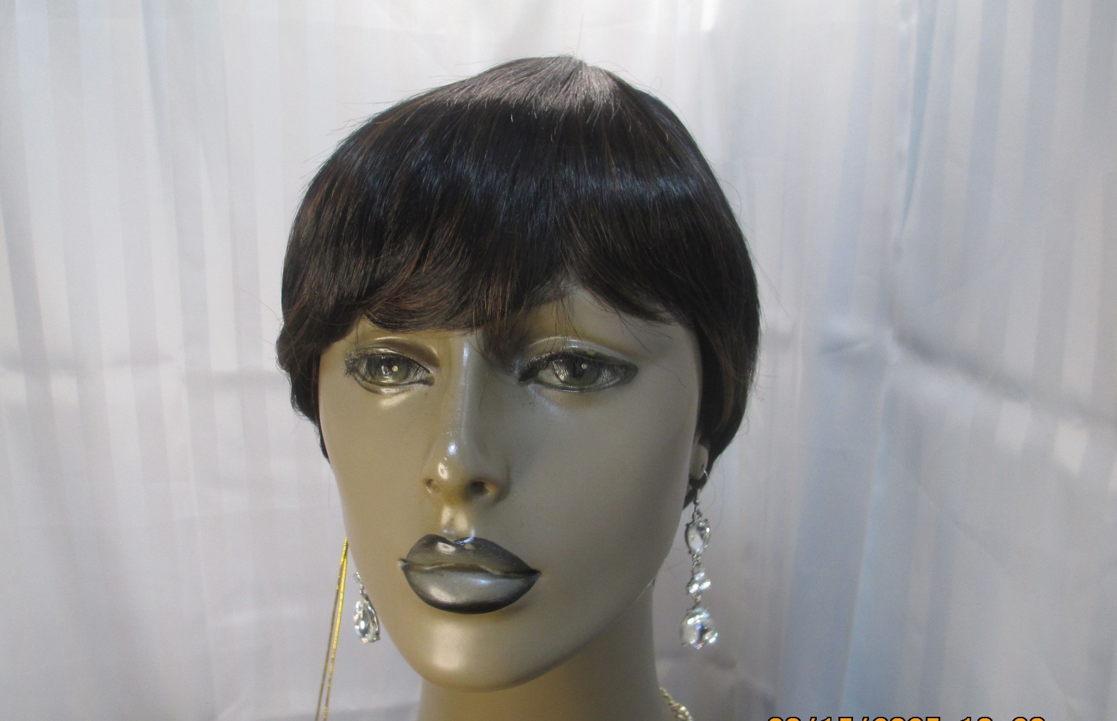 its a wig short sleek w/bangs black color 1B no styling heat safe cute NEW
