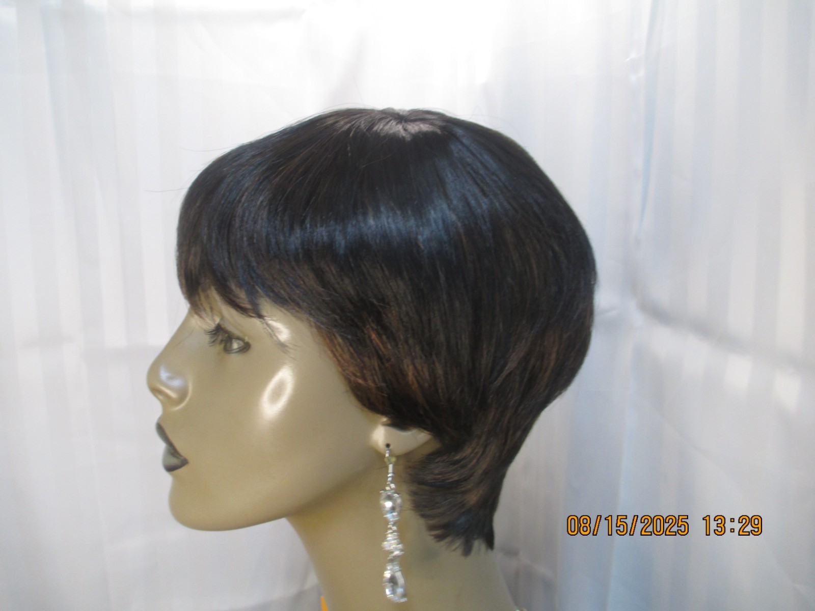 its a wig short sleek w/bangs black color 1B no styling heat safe cute NEW
