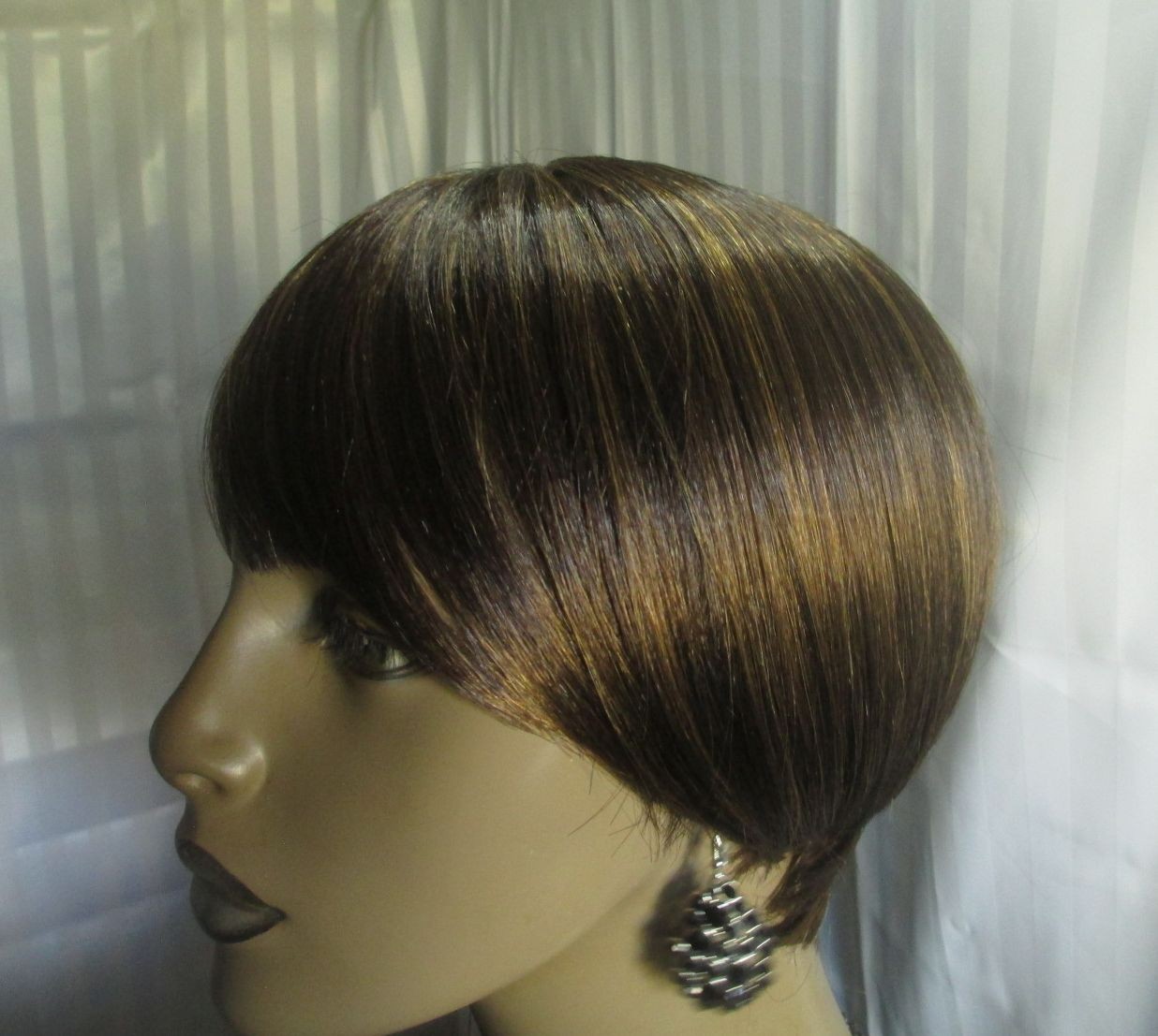 its a wig shortstraight w/bangs dark brown w/strawberry blonde easy to style NEW