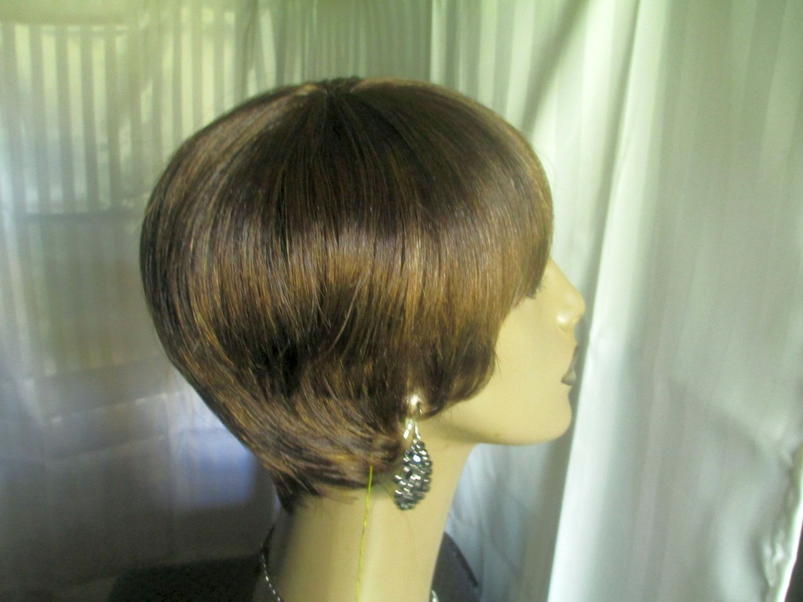 its a wig shortstraight w/bangs dark brown w/strawberry blonde easy to style NEW