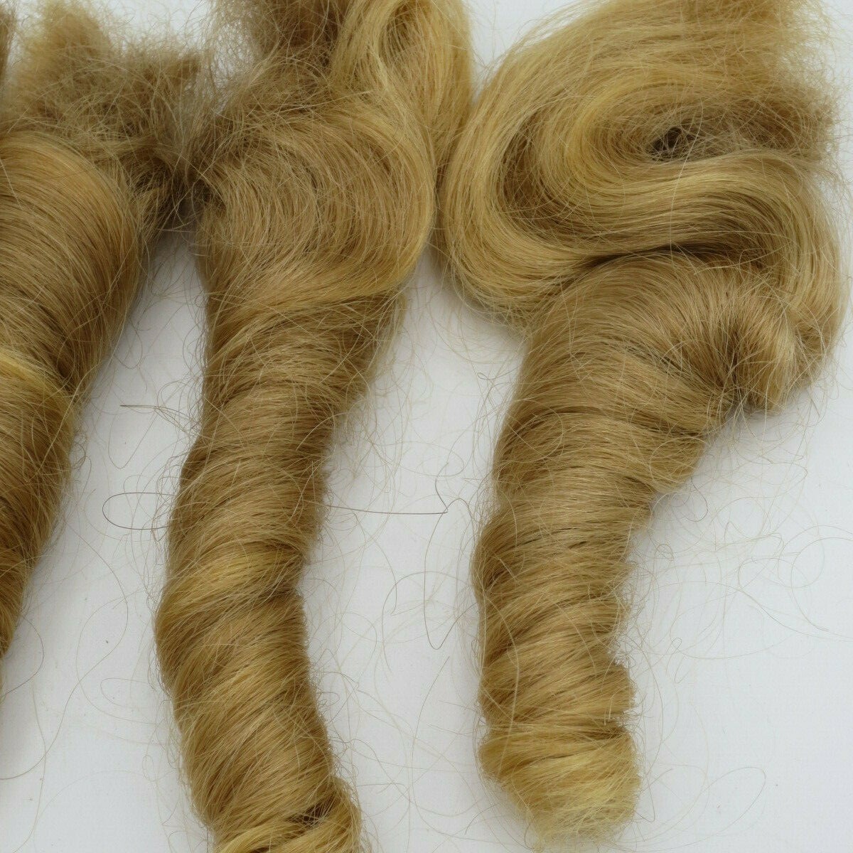 REAL CUT VIRGIN HUMAN HAIR – DIRTY BLONDE SPIRAL CURLS – SET OF 4 (5″ long)